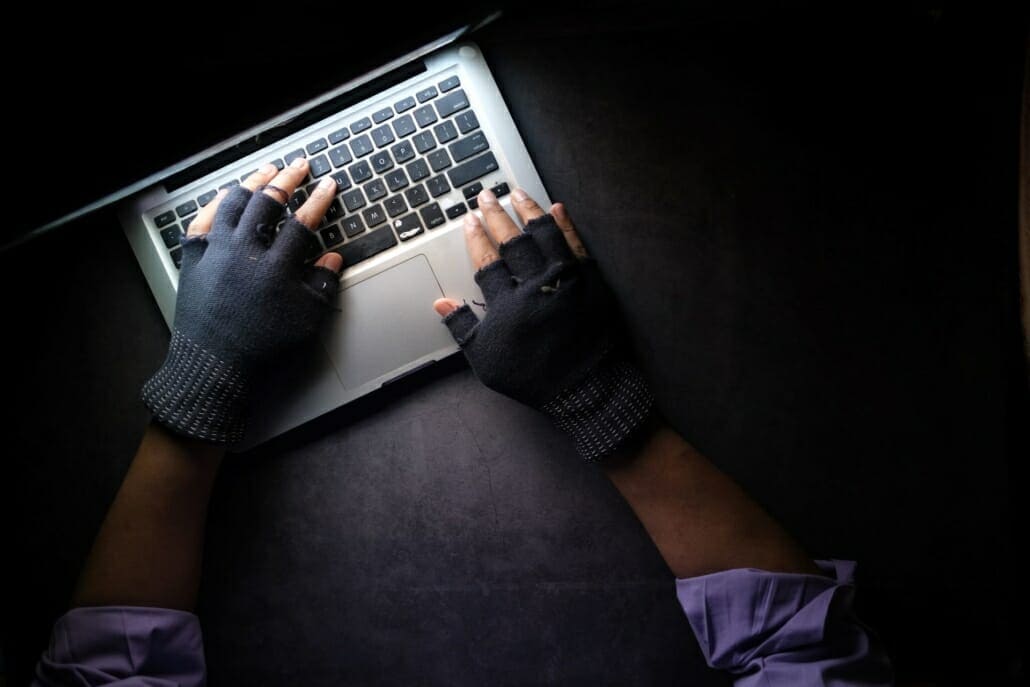 A cyber hacker using his laptop to create ransomware
