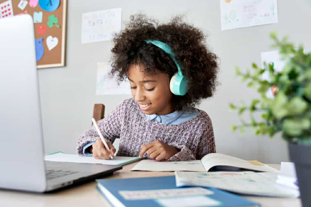 Student doing homework with their laptop and books