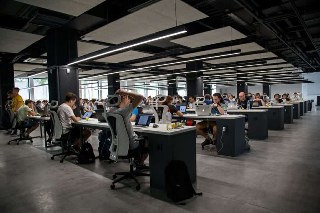 People working in an office on tech infrastructure such as servers, computers, firewall, etc.