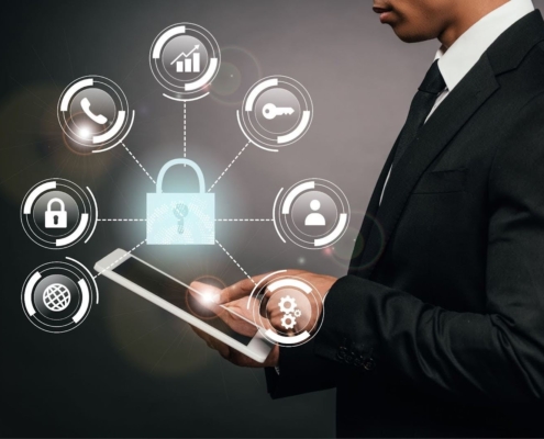 Man in suit holding tablet with infographic of lock, phone, key etc. IT management Concept
