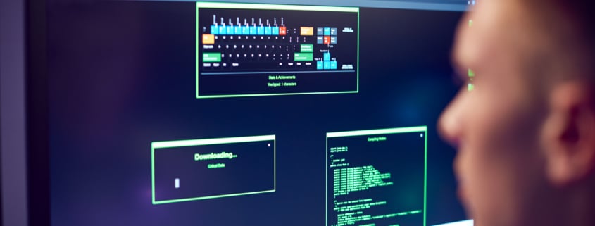 Male Teenage Hacker Sitting In Front Of Computer Screens Bypassing Cyber Security Cybersecurity protection for Richmond businesses concept