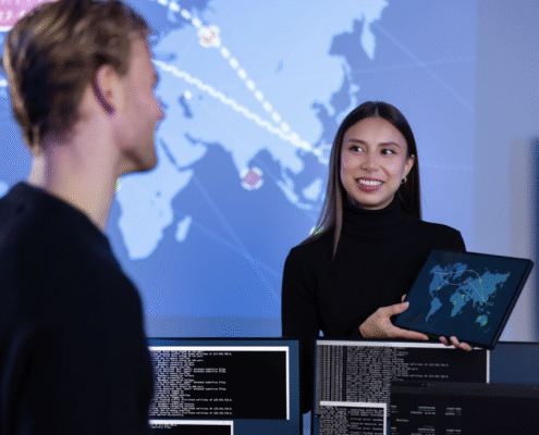 Smiling cyber security team working in a Cyber Security Operations Center