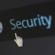 Computer screen displaying the word security with a cursor icon, representing IT security risk and access control