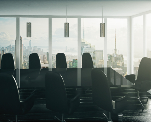 Modern executive conference room with floor-to-ceiling windows overlooking a city skyline, representing strategic technology leadership and business growth.