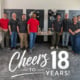 Bastionpoint Technology team celebrates 18 years in Richmond with balloons, cake, and a “Cheers to 18 Years” anniversary graphic.