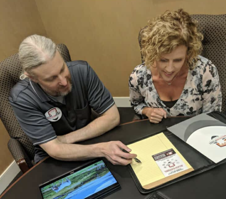 Bastionpoint Technology team member reviews documents with a client during an IT consultation.